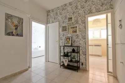 a room with a hallway with a painting on the wall at White Boutique Apartment in Rome