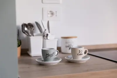 two coffee cups sitting on a kitchen counter at Rose of pyramid in Rome