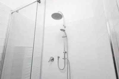 a shower with a glass door and a shower head at Rose of pyramid in Rome