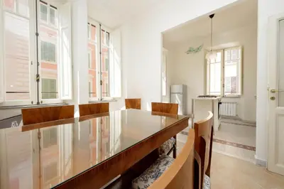 a dining room with a glass table and chairs at Carlo Felice in Rome