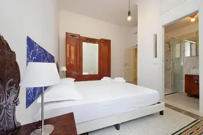 a bedroom with a white bed and a lamp at Carlo Felice in Rome