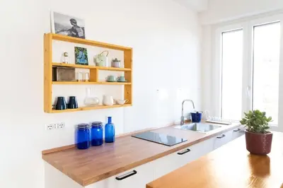 a kitchen with a wooden counter top and a sink at Cozy Pigneto Flat with Balcony in Rome