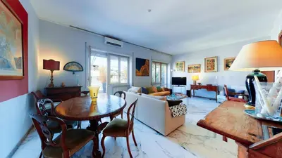 a living room with a table and a couch at FIORELLA's TERRACE in Rome