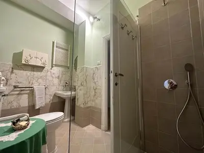 a bathroom with a shower and a toilet and a sink at FIORELLA's TERRACE in Rome