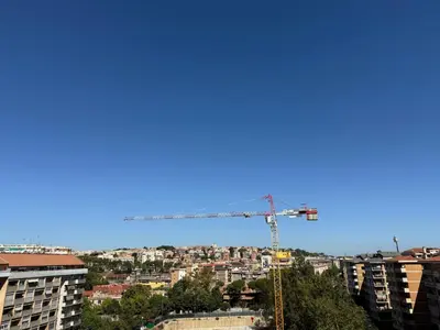 a construction crane and buildings in a city at Home in Roma in Rome