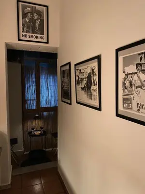 a no smoking sign on a wall with pictures at Casa Guardini in Rome in Rome