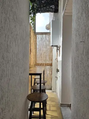 a table and stools in a hallway with a window at Casa Guardini in Rome in Rome