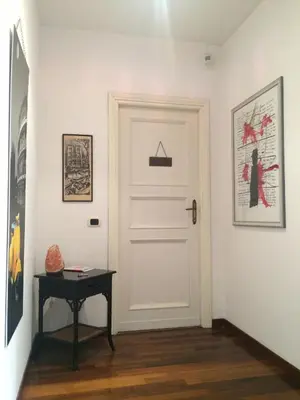 a hallway with a white door and a table at B&B Viale Dei Colli Portuensi 589 in Rome