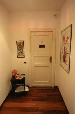 a hallway with a white door and a table at B&B Viale Dei Colli Portuensi 589 in Rome