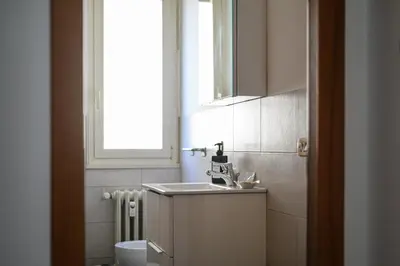 a small bathroom with a sink and a window at NEW Diana's place with terrace San Pietro Station in Rome