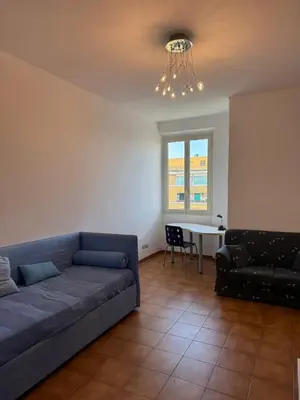 a living room with a couch and a table at House - Furio Camillo - Too in Rome