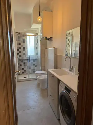 a bathroom with a toilet sink and a washing machine at House - Furio Camillo - Too in Rome