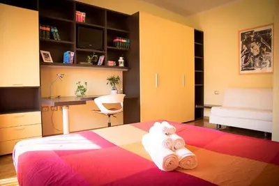 a bedroom with a bed with a teddy bear on it at Chat&Chill Vatican Apartment in Rome