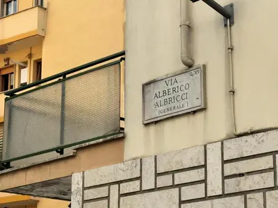 a sign on the side of a building at Banksy Urban Suite in Rome
