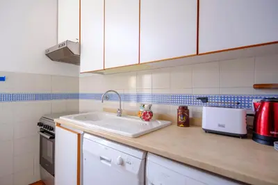 a kitchen with a sink and a counter top at Elegantis Monti Penthouse With Private Terrace and Colosseum View in Rome
