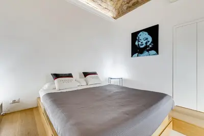 a bedroom with a large bed in a white room at Vatican Scipioni Charming Studio relaxing and patio in Rome
