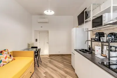 a kitchen with a yellow couch in a room at Albadoro Apartment in Rome