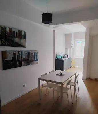 a white room with a table and chairs in it at TiburtinaStay in Rome