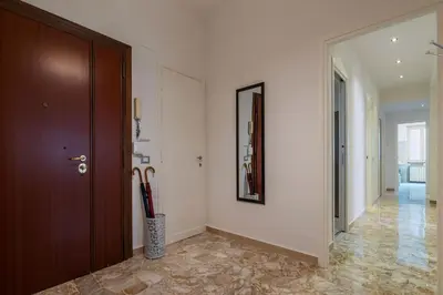 a hallway with a brown door and a hallway with a hallway at GuestHost - Trastevere Apartment Roma Portuense in Rome