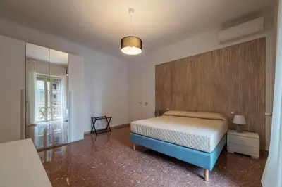 a bedroom with a bed and a large window at GuestHost - Trastevere Apartment Roma Portuense in Rome