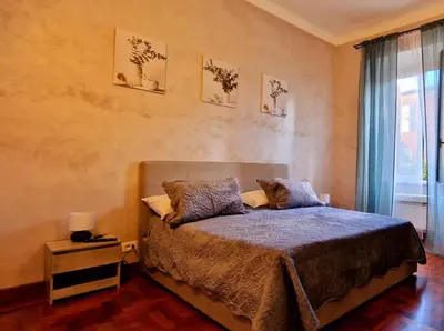 a bedroom with a bed and a window at Aurelio Vatican Holiday in Rome
