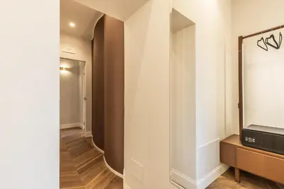 a hallway with a mirror and a tv on a wall at Porta Trastevere Palace in Rome