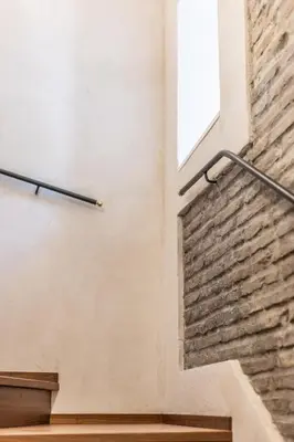 a brick wall with a window and stairs at Porta Trastevere Palace in Rome