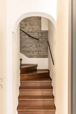a staircase in a house with a brick wall at Porta Trastevere Palace in Rome
