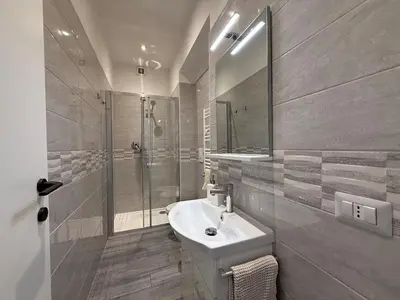 a white bathroom with a sink and a shower at Casa di Mara by Valentina's Dream in Rome