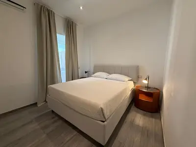 a bedroom with a white bed and a window at Casa di Mara by Valentina's Dream in Rome