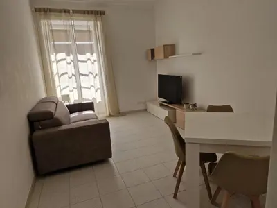 a living room with a couch and a table and a television at Alessandro's Home in Rome