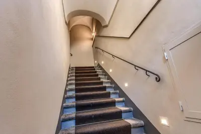 a hallway with stairs in a building with an arch at AGH Pantheon in Rome
