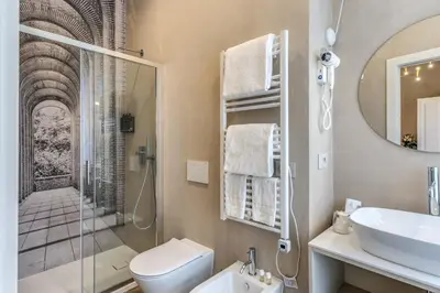 a bathroom with a toilet and a sink and a shower at AGH Pantheon in Rome