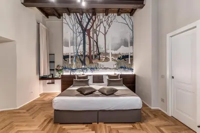 a bedroom with a bed with a painting on the wall at AGH Pantheon in Rome