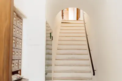 a set of stairs leading up to a door at The Oasis of Trastevere in Rome