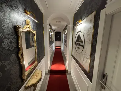 a hallway with a red carpet and a mirror on the wall at Lary's - San Pietro in Rome
