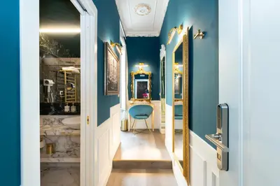 a bathroom with blue walls and a blue chair at Lary's - San Pietro in Rome