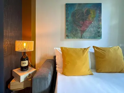 a bedroom with a bed with a lamp and a painting at Wine Stay, relaxation and style in Rome in Rome