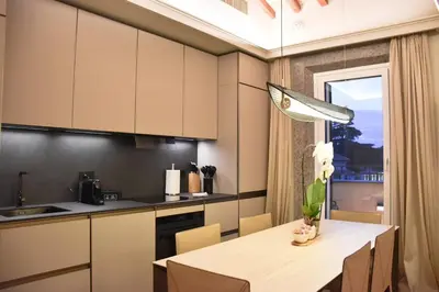 a kitchen and dining room with a table and a window at Spanish Steps - Luma Suite - Terraces & Rome View in Rome