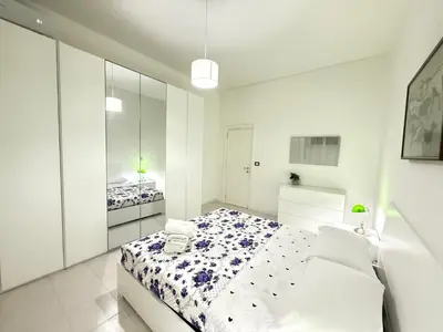 a white bedroom with a bed and a couch at Always Home in Rome