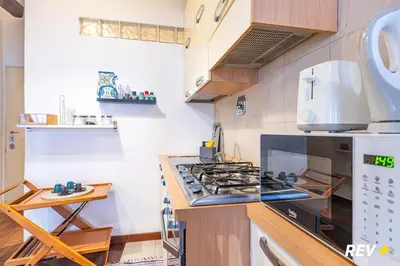 a kitchen with a stove top oven next to a counter at Banchi Nuovi Apartment in Rome