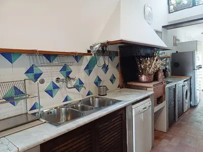 a kitchen with a sink and a tiled wall at Del Cinque Heritage - Charme Holidays in Rome