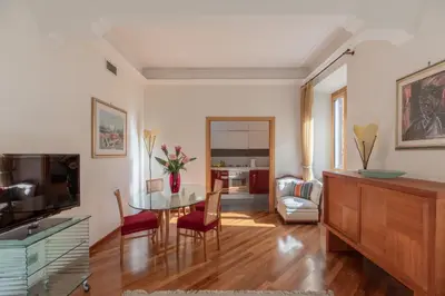 a living room with a table and chairs and a television at iFlat Vintage Retreat - Comfort in Central Rome in Rome