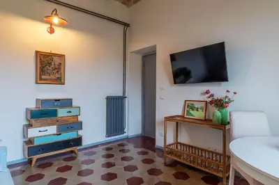 a living room with a tv on the wall at GuestHost - Elegant Apartment Testaccio Roma in Rome