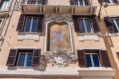 a painting of a woman on the side of a building at Madonna del Pantheon in Rome
