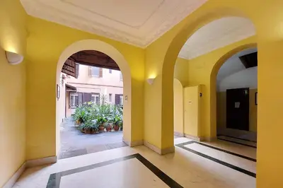 an empty hallway with yellow walls and arches at Maison Florienne in Rome