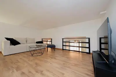 a living room with a white couch and a table at Maison Florienne in Rome