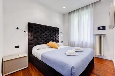 a bedroom with a large bed with two towels on it at Luxury Ludo House Trastevere in Rome