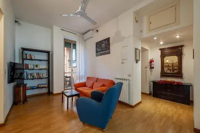 a living room with a couch and a chair at GuestHost - Comfy Apartment Garbatella Roma in Rome