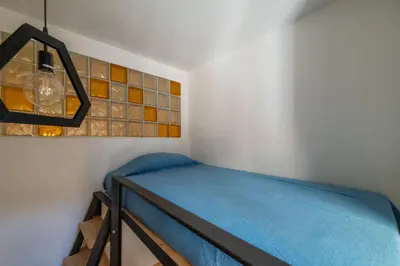 a small room with a bed and a lamp at GuestHost - Comfy Apartment Garbatella Roma in Rome